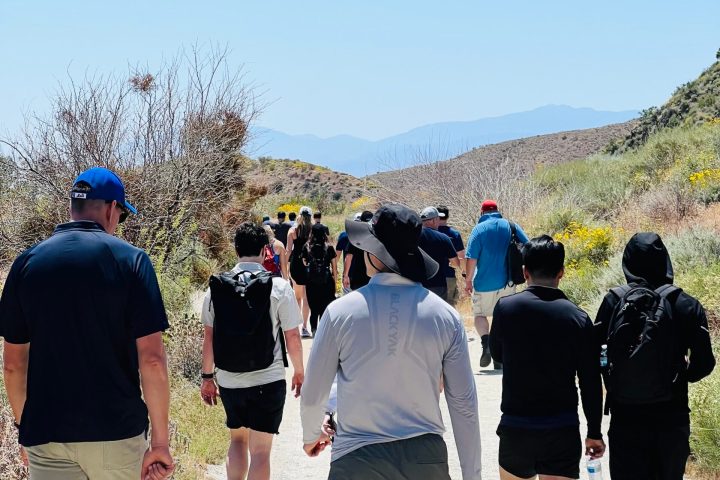 a group of people standing around each other