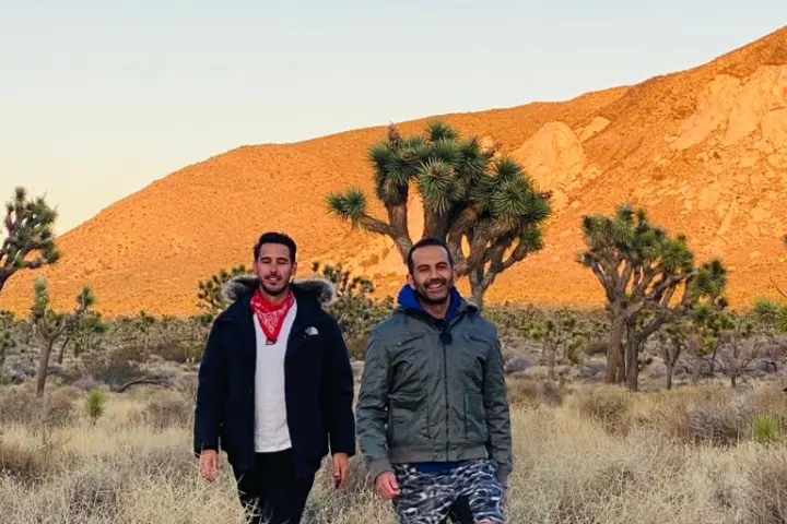two guests standing in a field on a joshua tree group tour