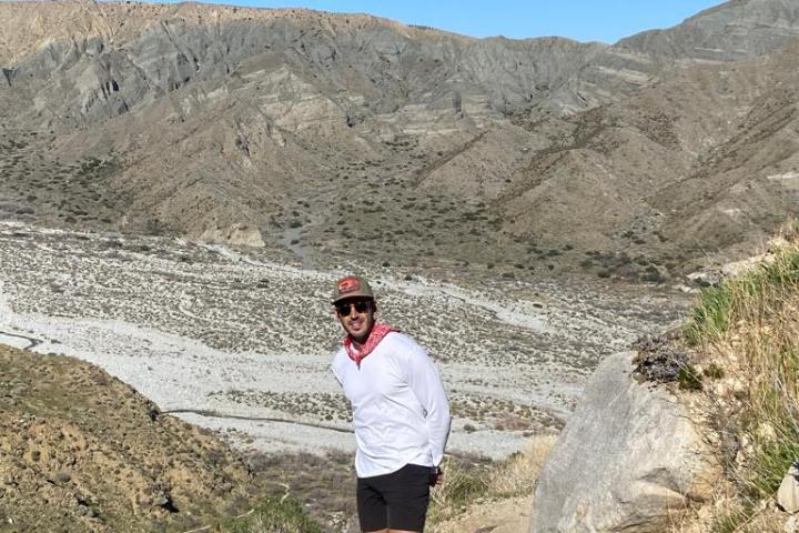 a person on top of a mountain on a palm springs group tour