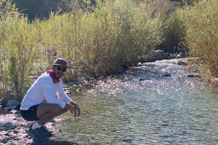a guest next to a stream on a palm springs white water tour