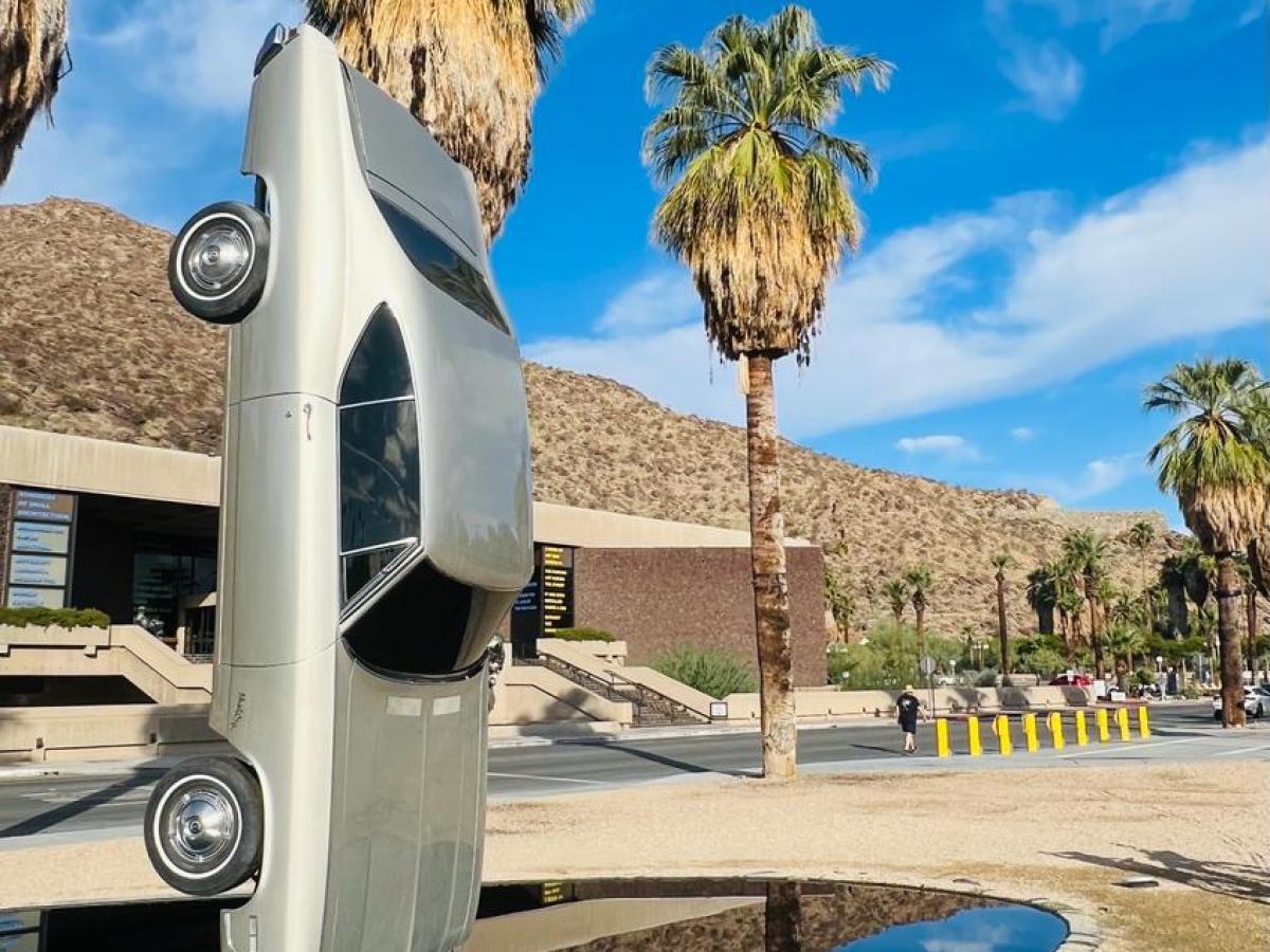 a statue of a car sideways on a downtown palm springs tour