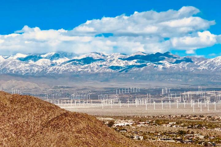 a group of mountains above a field of fans in the desert