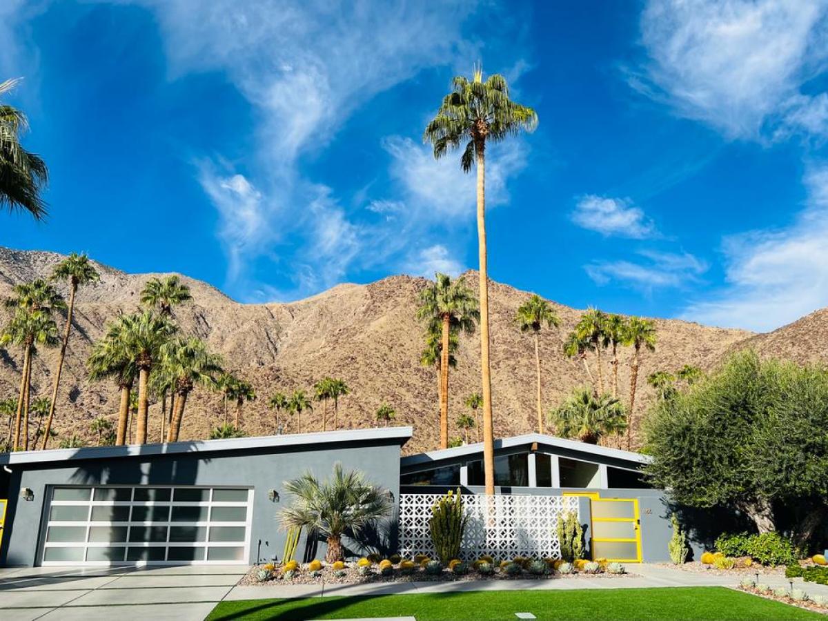 a house with a mountain in the background on a palm springs group tour