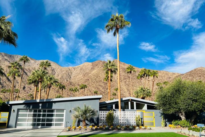 a house with a mountain in the background on a palm springs group tour