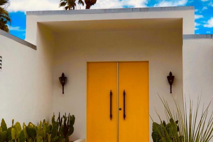 a white house with two yellow doors