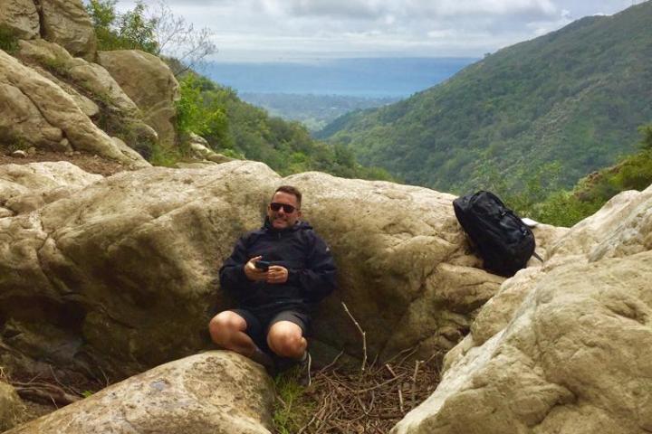 a person sitting on a rock on a santa barbara group tour