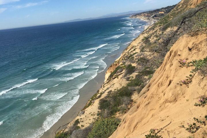 a rocky beach next to a body of water