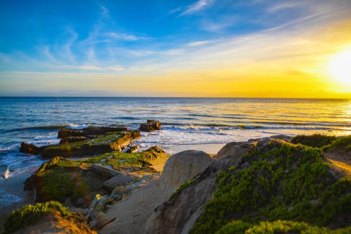 a rocky beach next to a body of water