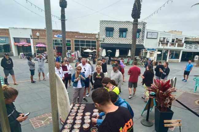 a group of people on a sidewalk on a group tour