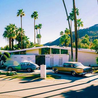 cars parked outside of a house in palm springs on a palm springs tour