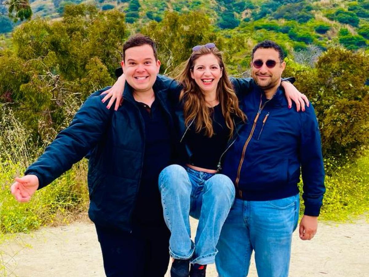 a group of people posing for the camera on a hollywood sign tour