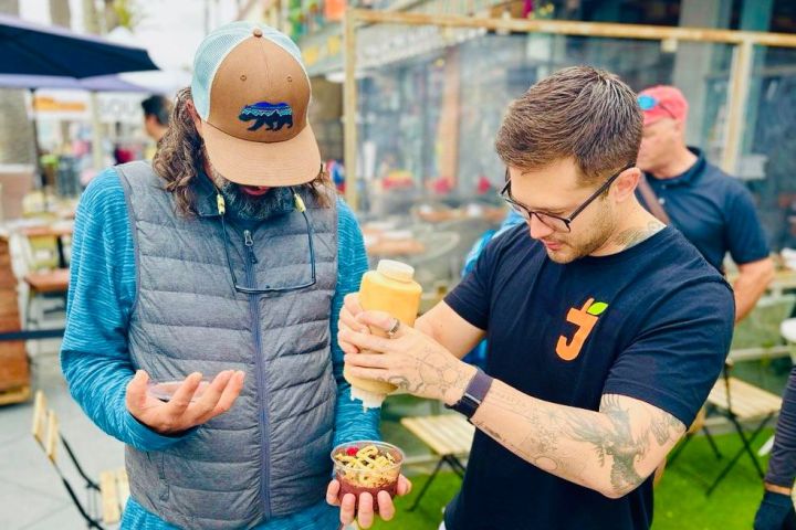 a group of people looking eating on a bikes and bites food tour