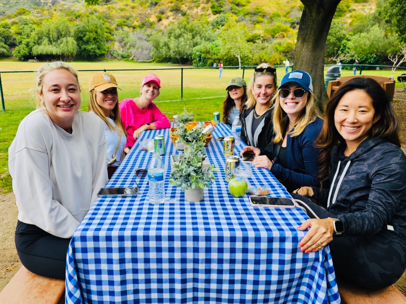 a group of people around a picnic table enjoying a hollywood sign tour