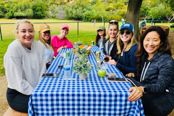 a group of people around a picnic table enjoying a hollywood sign tour