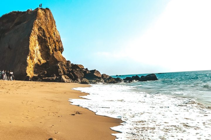 a rocky beach next to the ocean on a custom los angeles rock climbing adventure