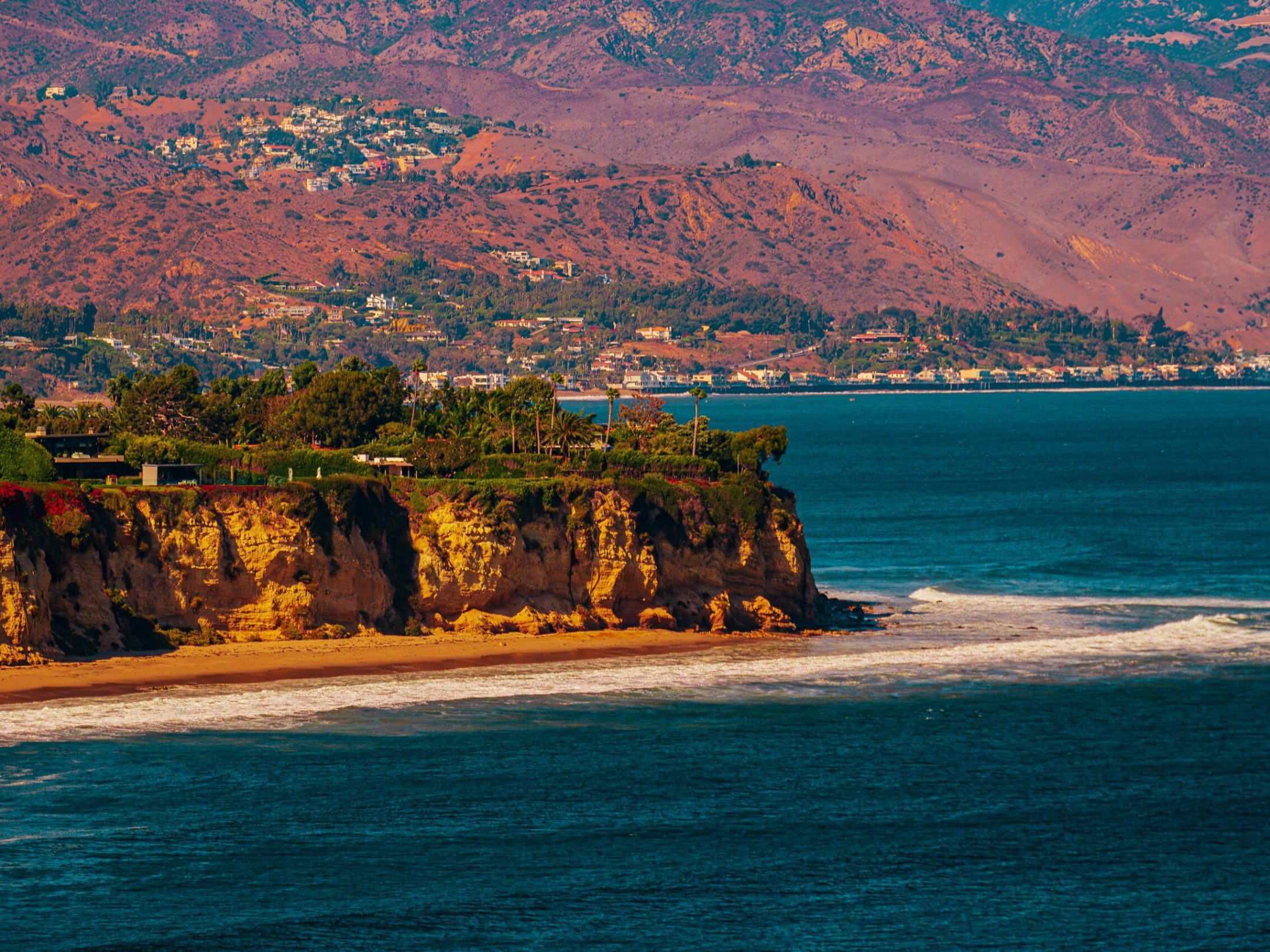 a body of water with a mountain in the background