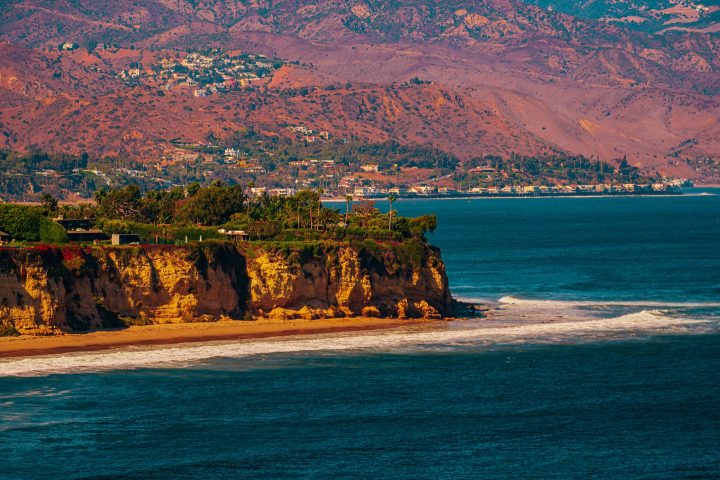 a body of water with a mountain in the background