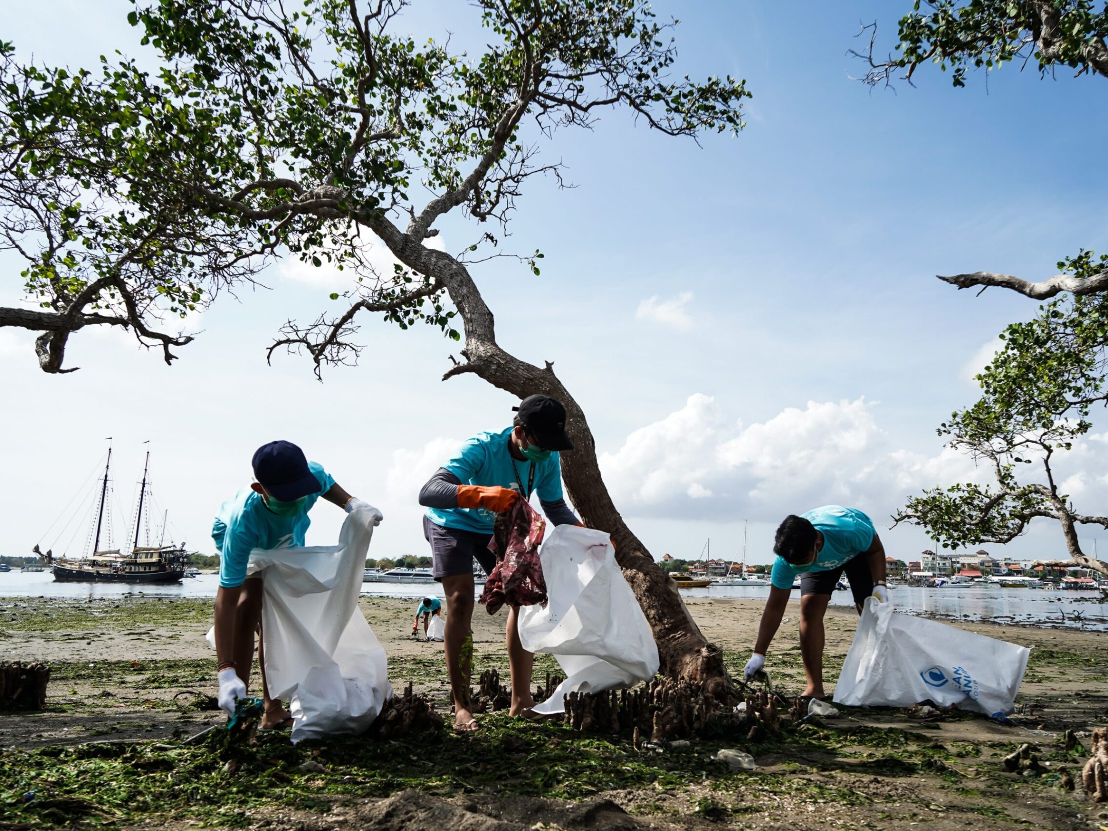 a group of people standing next to a tree