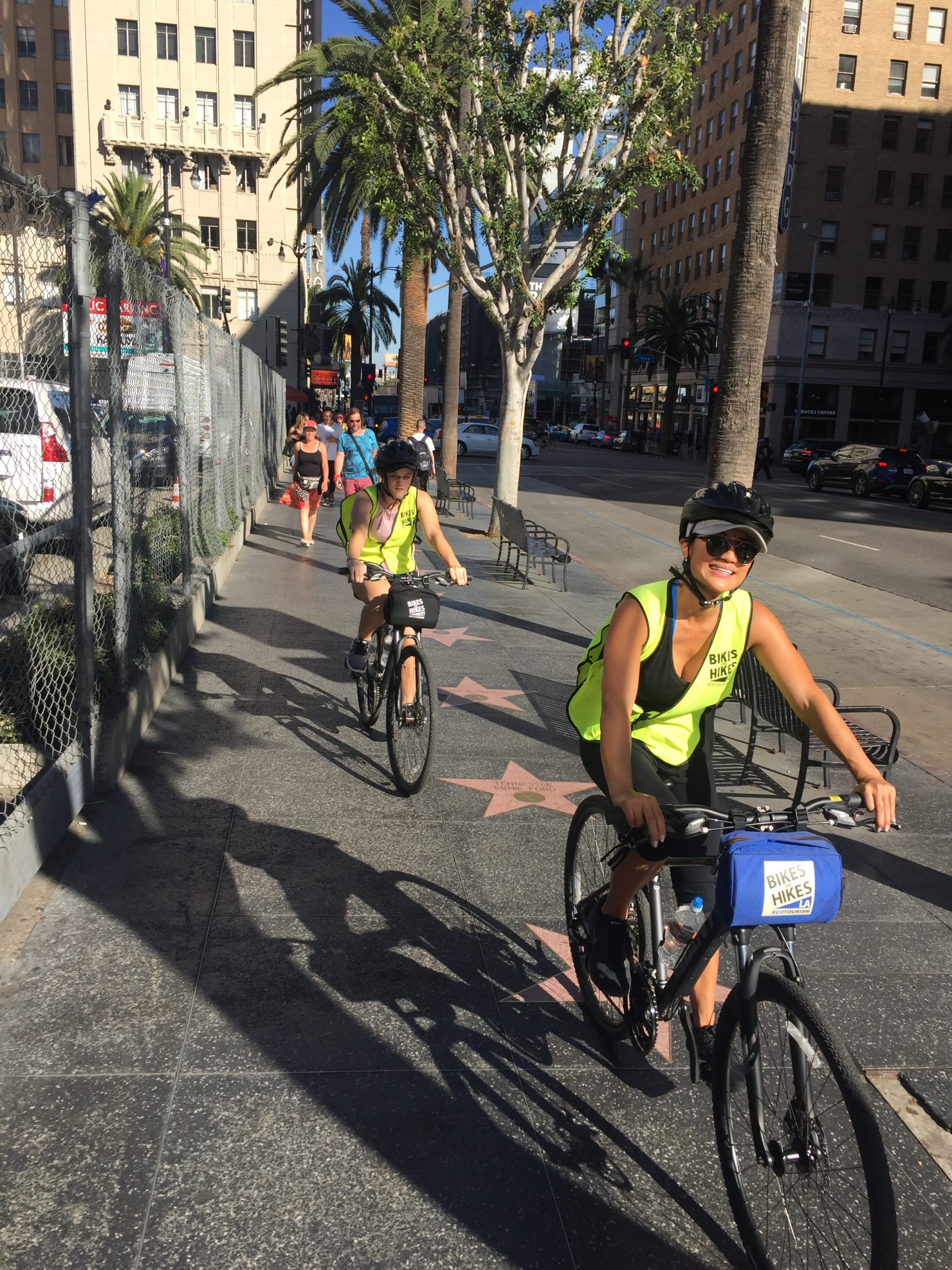 a group of people riding bikes on a city street