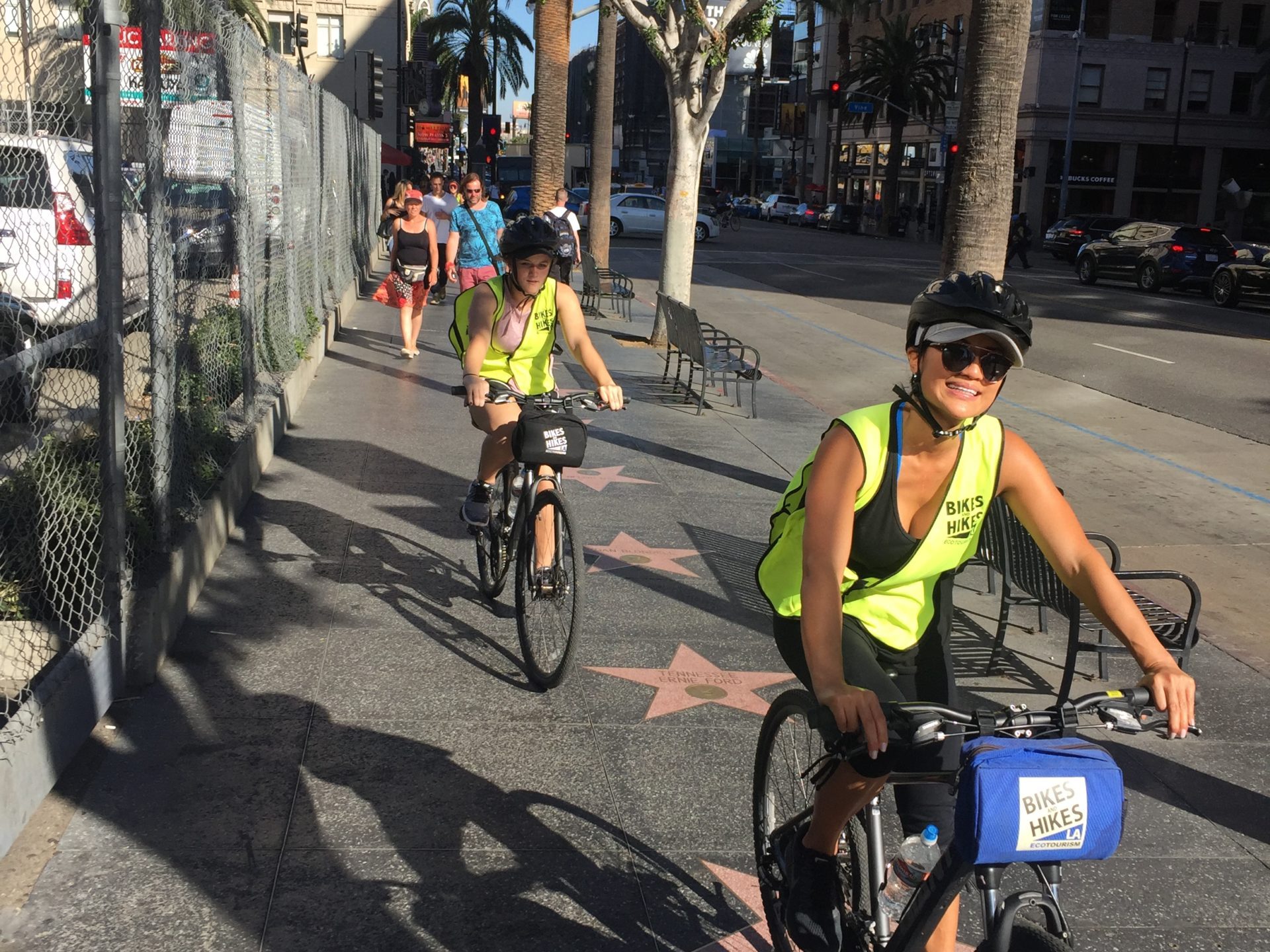 a group of people riding bikes on a city street