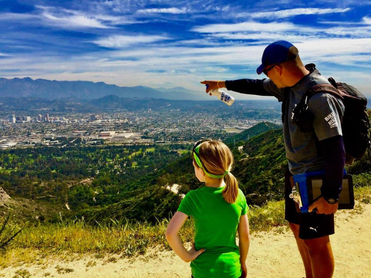 Tour guide and child at the top of a mountain