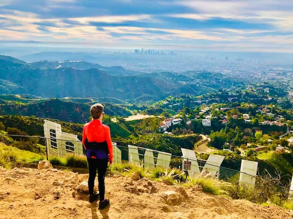 a man standing in front of a mountain