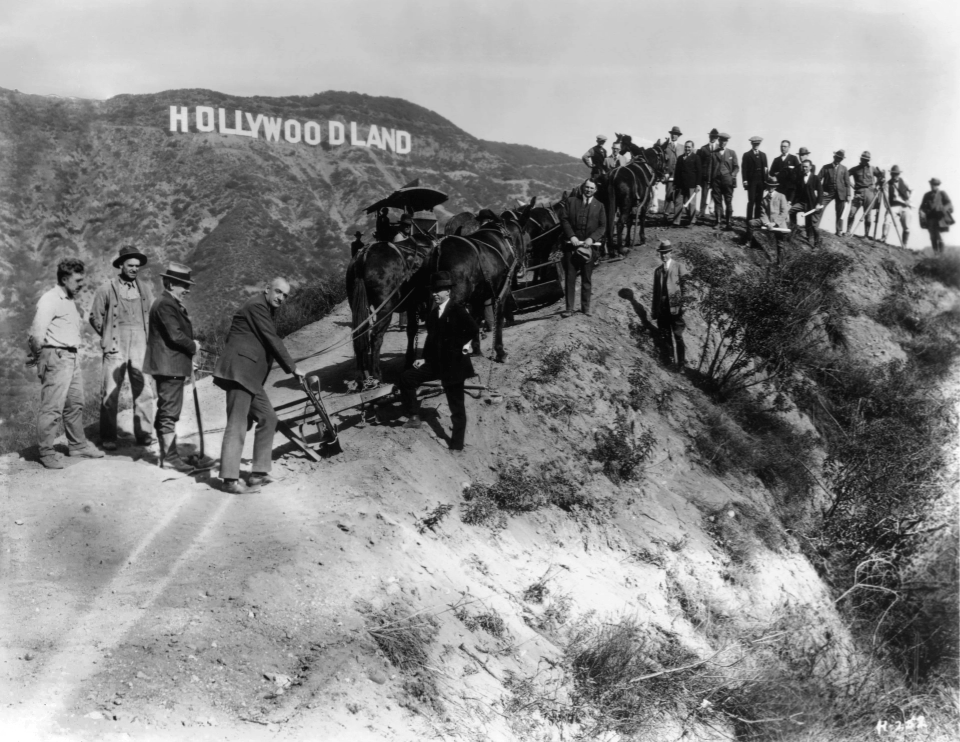 image001 a group of people riding on the back of a horse drawn carriage