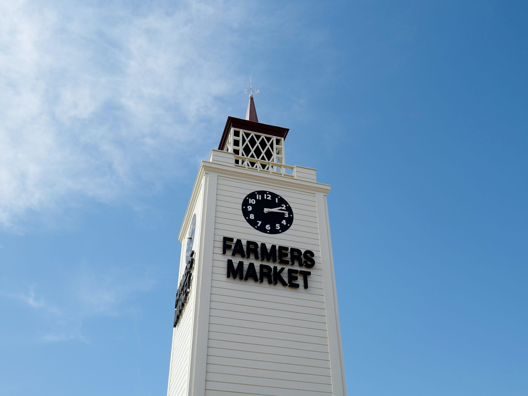 a large tall tower with a clock on the side of a building