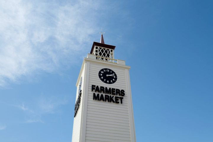 a large tall tower with a clock on the side of a building