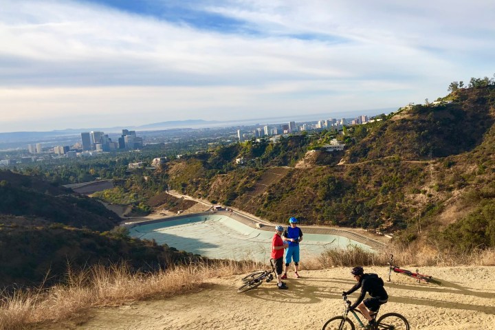 a man riding a bike down a dirt road