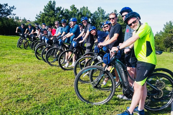a group of people standing around a motorcycle