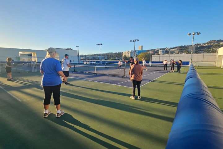 a group of people walking on the court