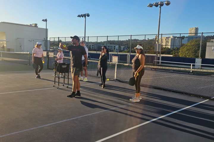 a group of people walking on the court