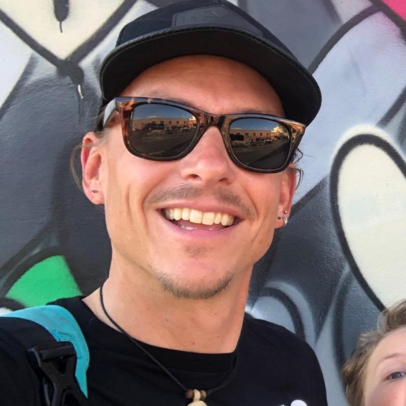 a person wearing sunglasses and smiling