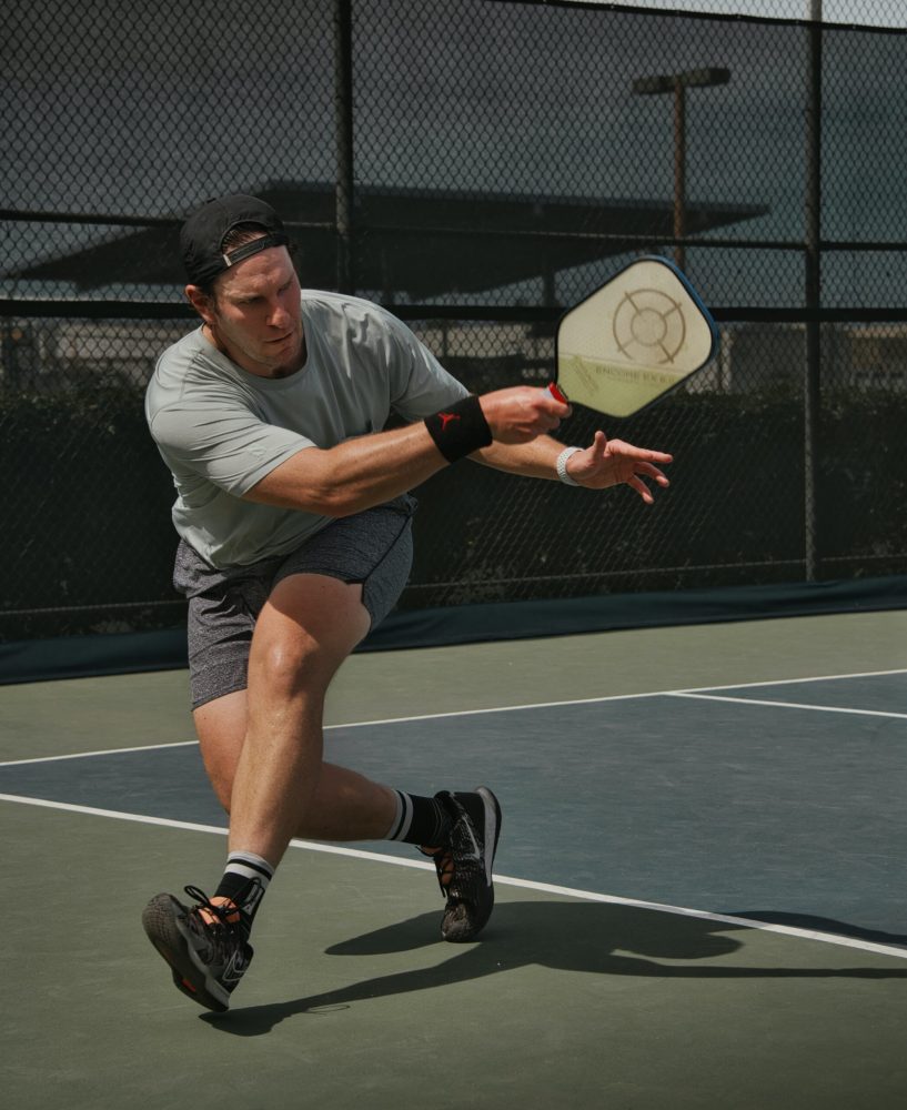 a man is swinging a racket at a ball