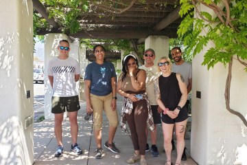 A group of tour guest posing in downtown ojai