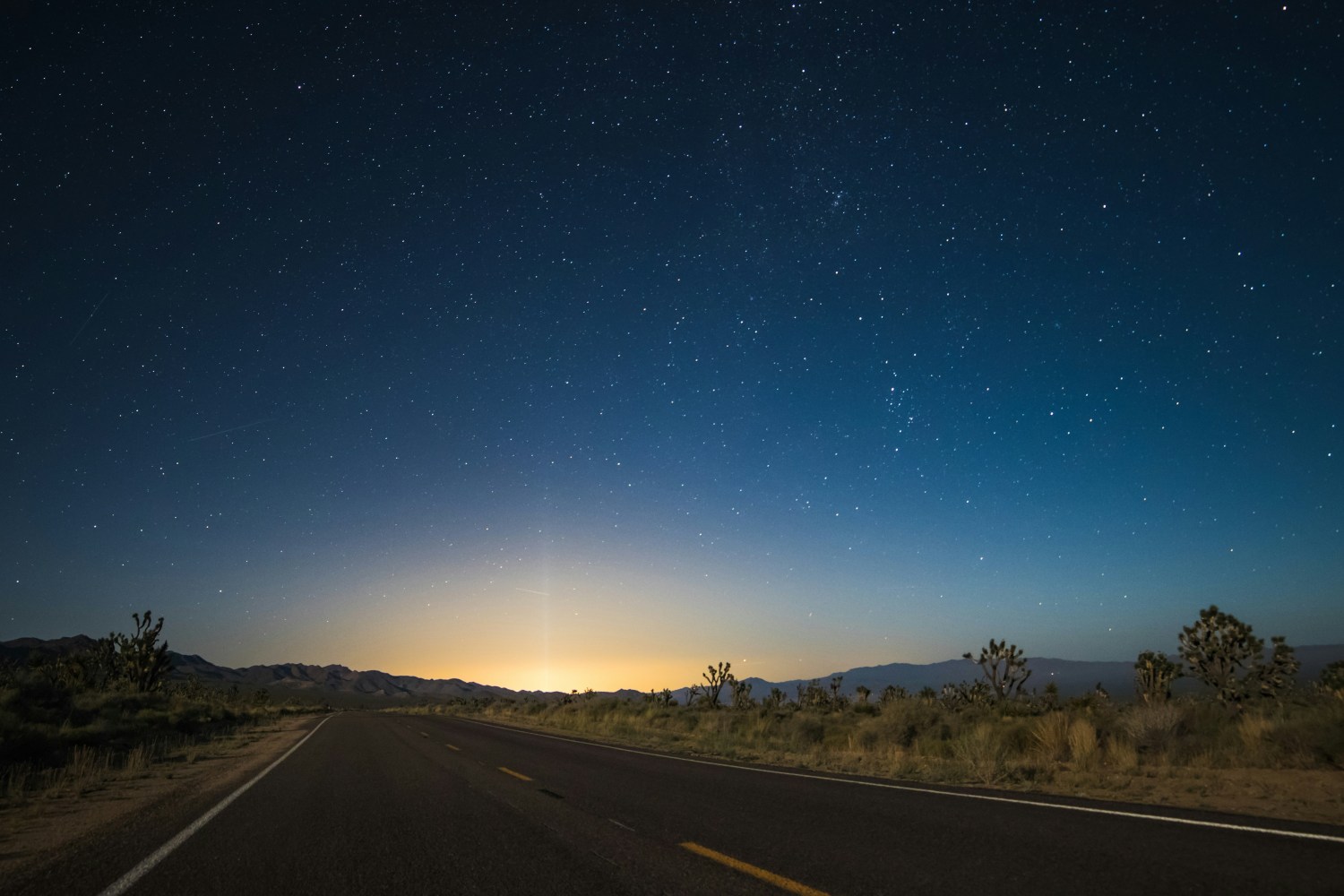 a night sky with the sun behind them