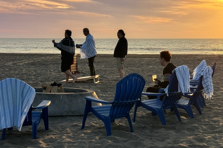 a group of people sitting at a beach