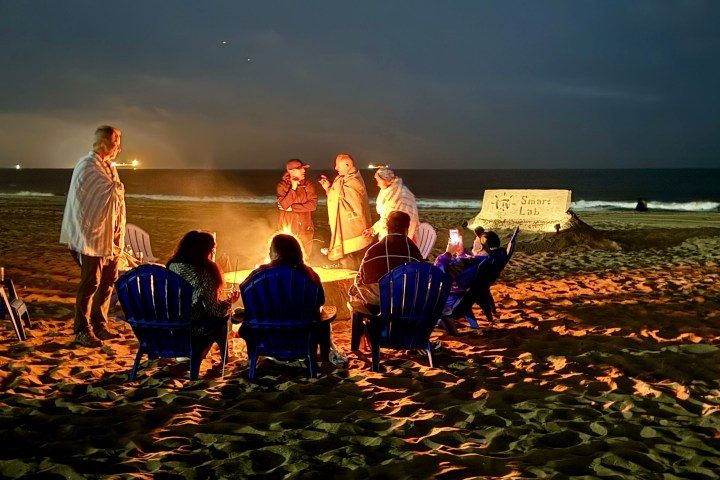 a group of people sitting at a beach