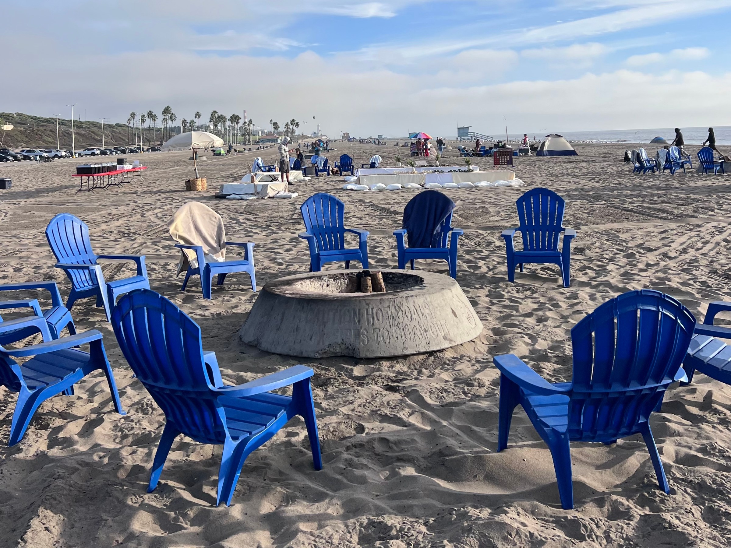 a group of people sitting at a beach