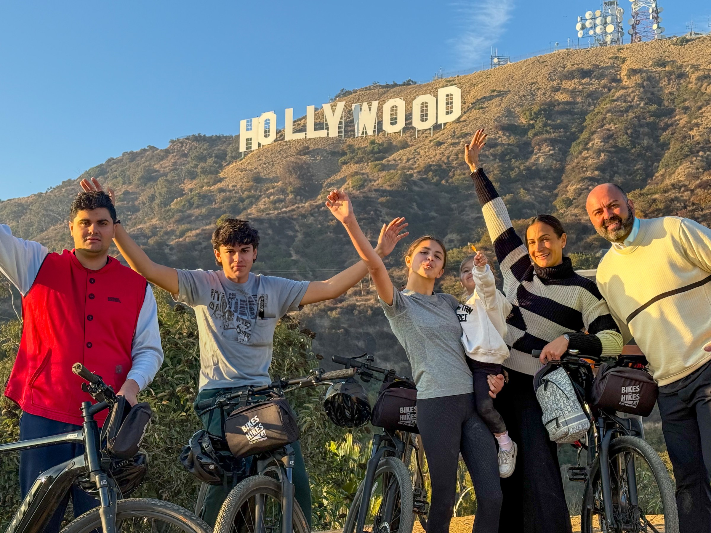 a group of people riding on the back of a bicycle