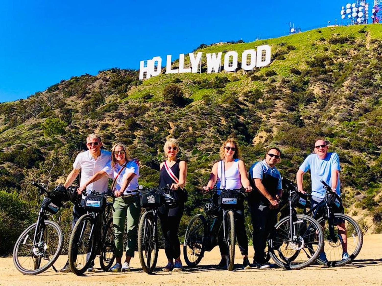 a group of people riding on the back of a bicycle